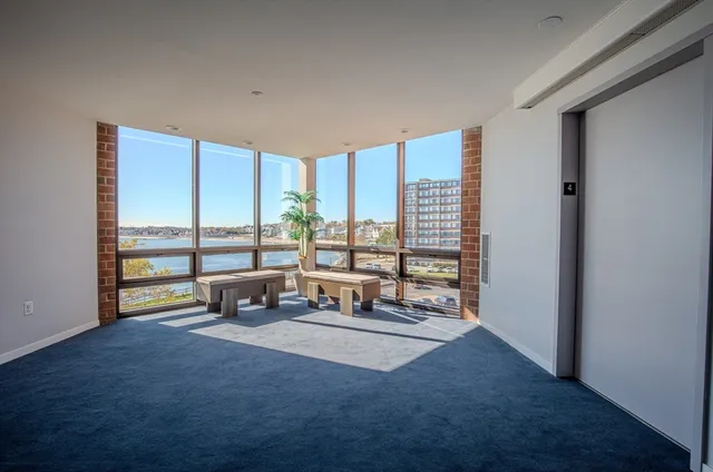 a room with furniture pool table and windows