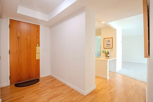 a living room with furniture a flat screen tv and a floor to ceiling window