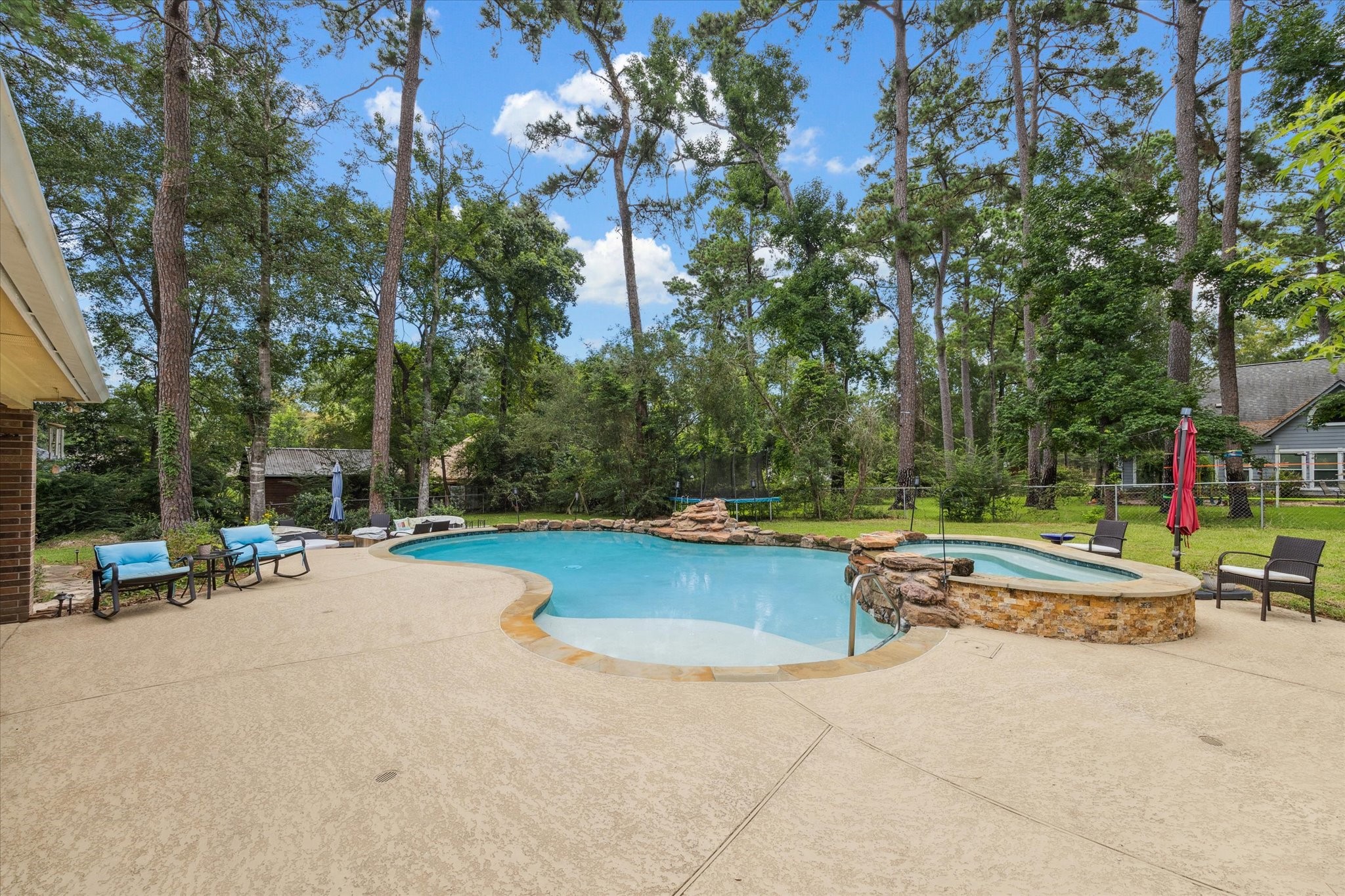 23818 Pin Oak Drive Spring, TX 77389 - Photo 1 of 31 a view of a swimming pool with lounge chair and lounge chairs