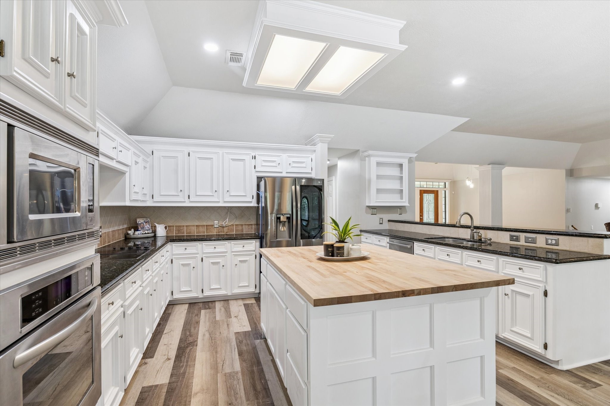 23818 Pin Oak Drive Spring, TX 77389 - Photo 15 of 31 a kitchen with granite countertop a sink stove and cabinets