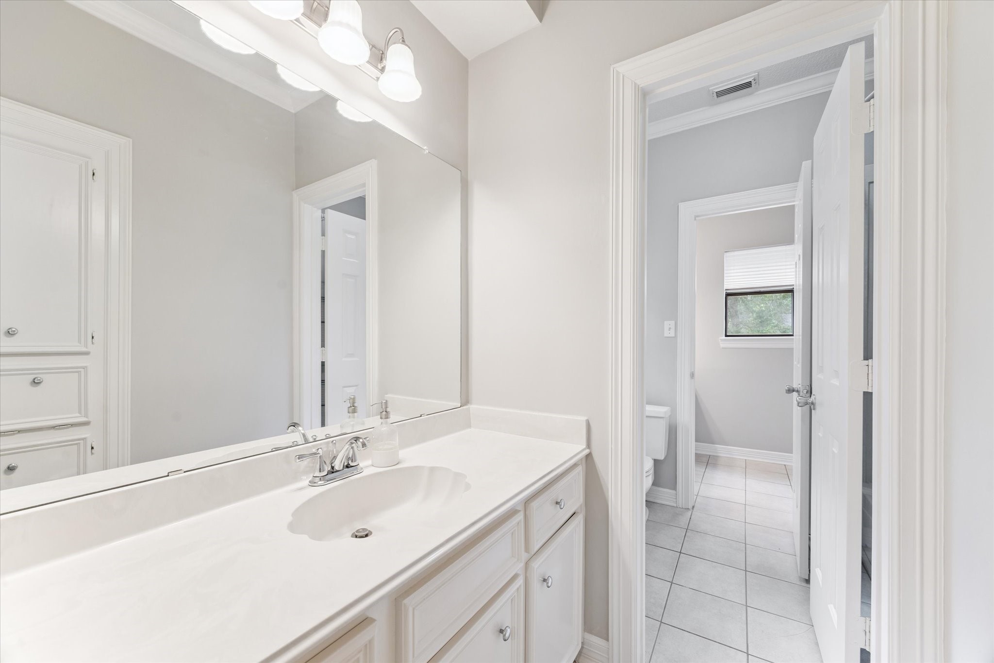 23818 Pin Oak Drive Spring, TX 77389 - Photo 26 of 31 a bathroom with a sink a vanity and a mirror