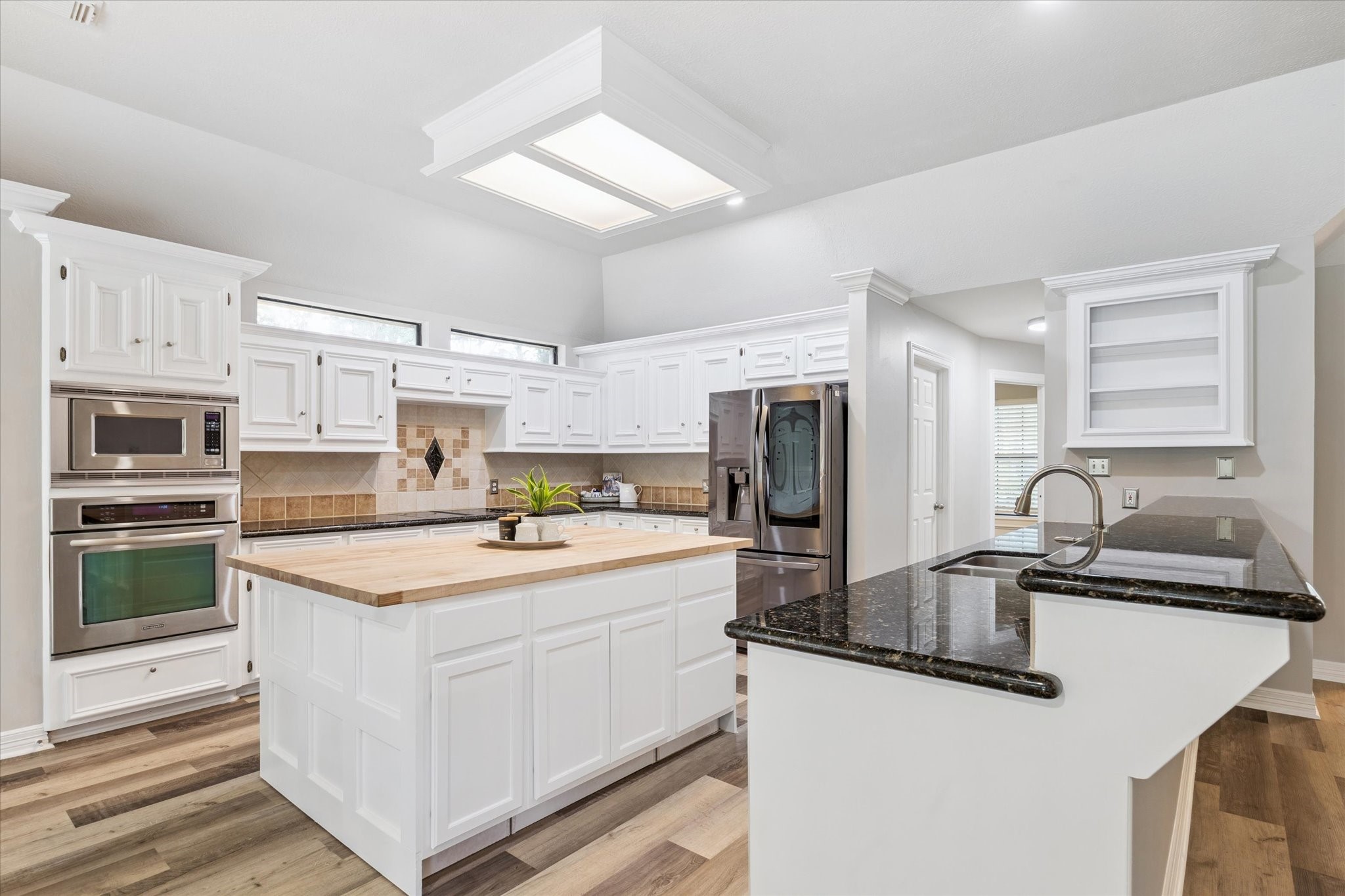 23818 Pin Oak Drive Spring, TX 77389 - Photo 7 of 31 a kitchen with stainless steel appliances granite countertop a sink stove refrigerator and cabinets