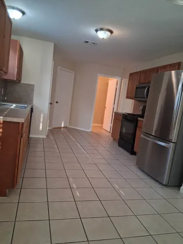 a view of a kitchen with an empty space and a window