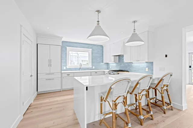 a view of a a dining room with furniture window and wooden floor