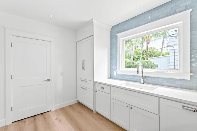 a kitchen with stainless steel appliances a stove a microwave and white cabinets