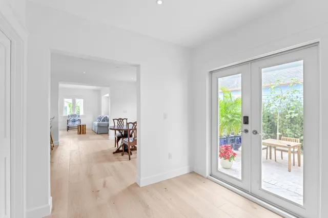 a view of a room with wooden floor and windows