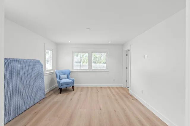 a view of a livingroom with workspace and a window