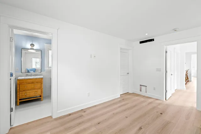 a view of a bedroom with wooden floor and chair