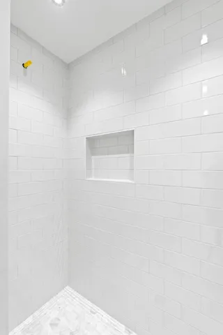 a bathroom with a granite countertop toilet sink and mirror