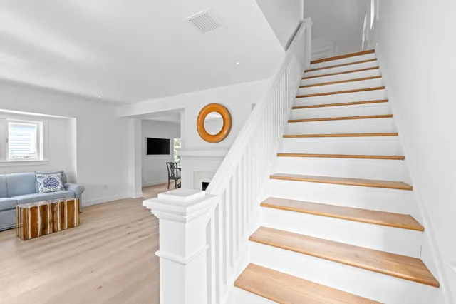 a view of entryway and hall with wooden floor