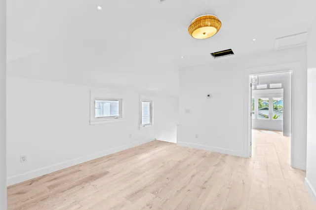 a view of a room with wooden floor and window