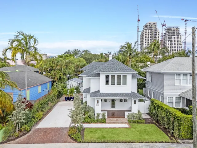 a front view of a house with a garden and plants