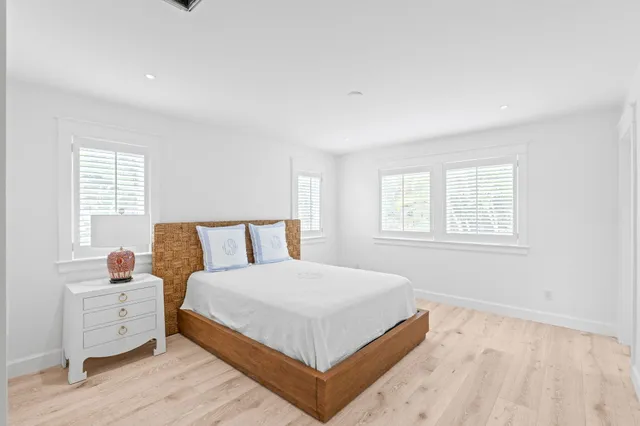 a large bed sitting in a bedroom next to a window