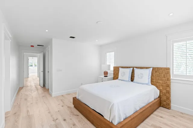 a large white bed in a white room