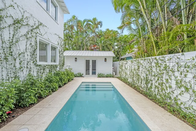 a wooden bench sitting in front of a house