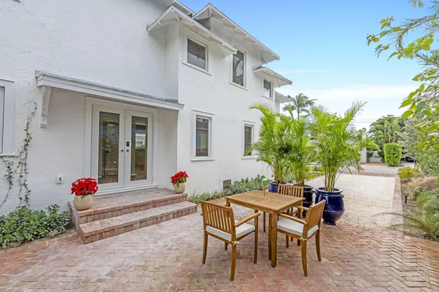 a front view of a residential apartment building with a yard and parking space