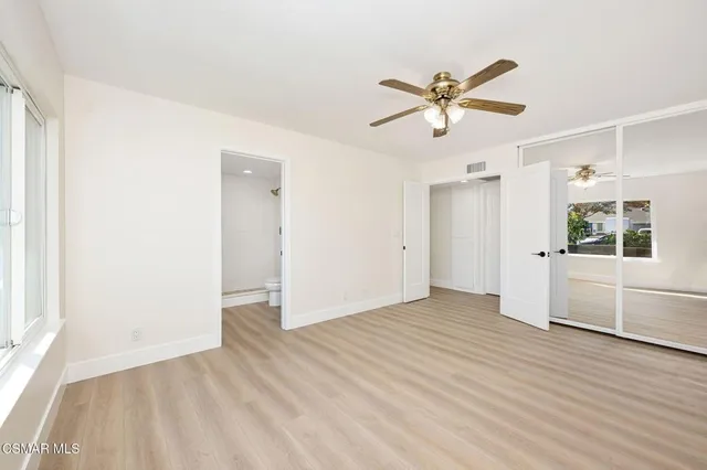 a view of a livingroom with a ceiling fan and window