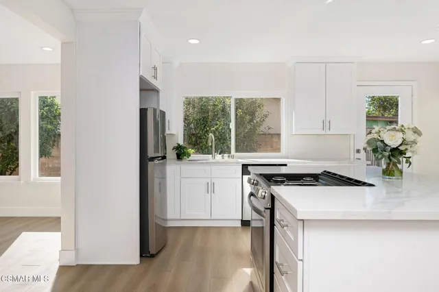 a kitchen with a stove a sink and a refrigerator