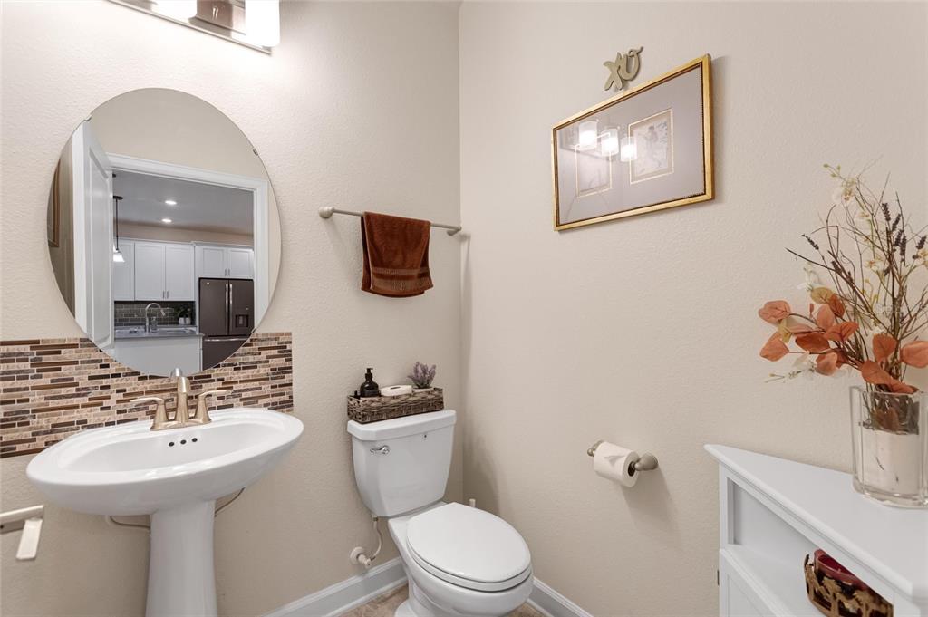 1089 Blackwolf Run Road Davenport, FL 33896 - Photo 11 of 82 a bathroom with a toilet sink and mirror