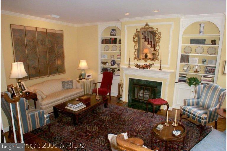 a living room with furniture a fireplace and decor