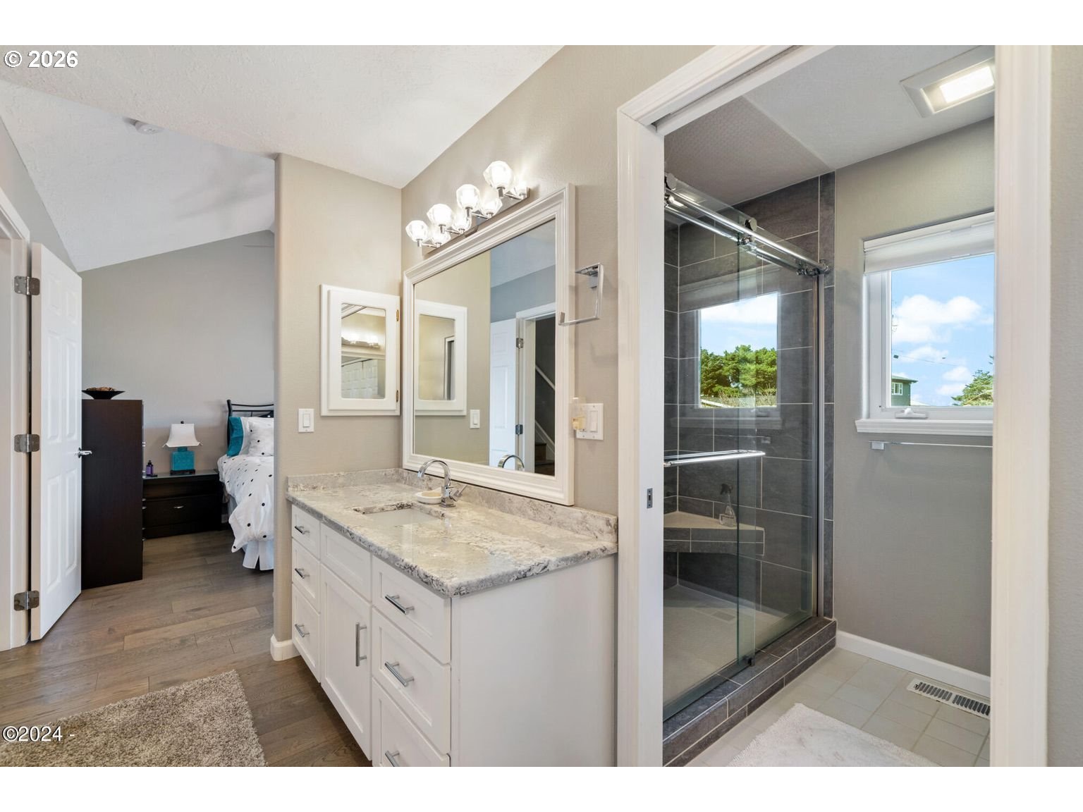 465 Edgewater Depoe Bay, OR 97341 - Photo 19 of 48 a bathroom with a granite countertop sink a mirror and a shower