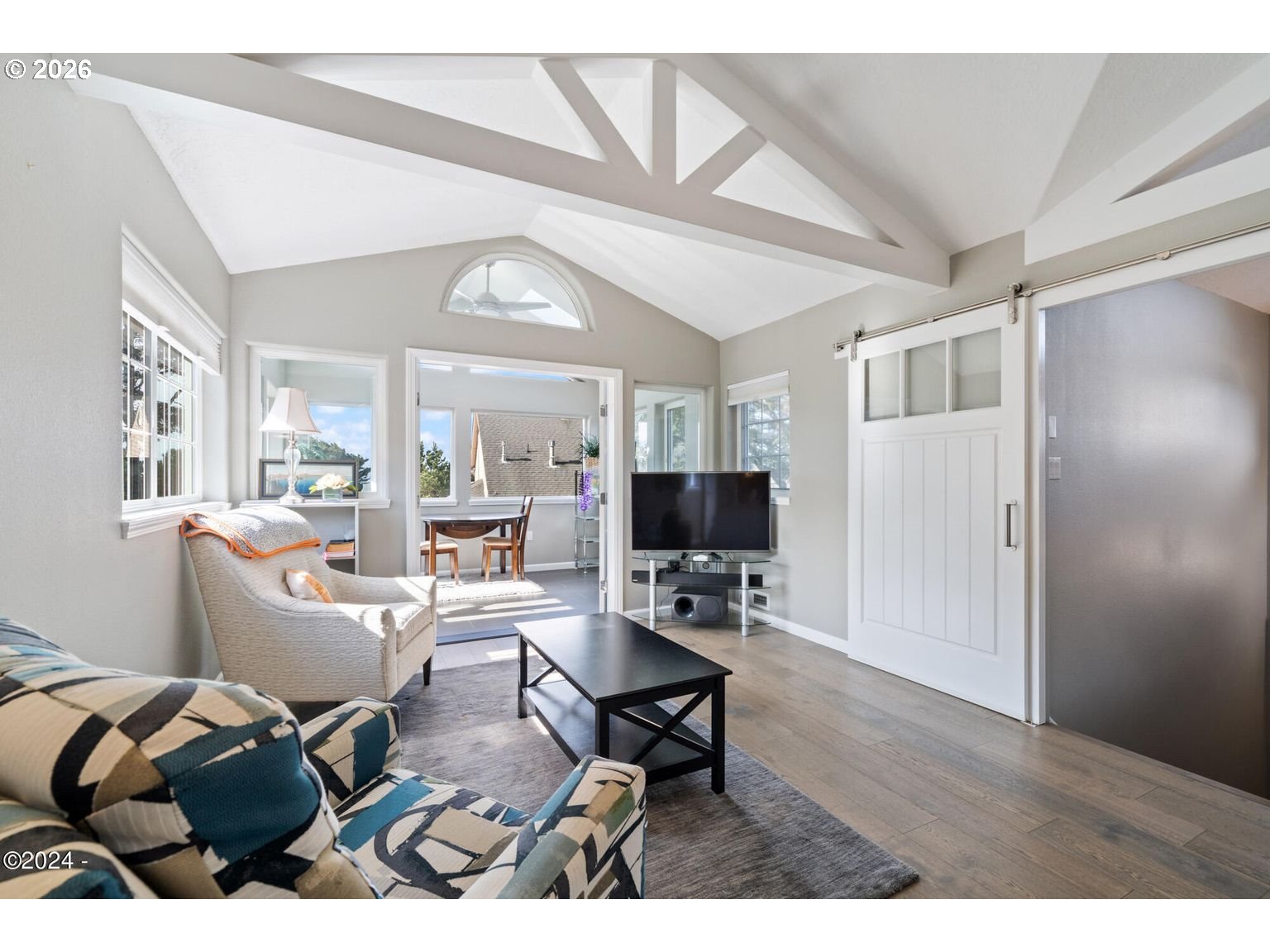 465 Edgewater Depoe Bay, OR 97341 - Photo 34 of 48 a living room with furniture a wooden floor and a flat screen tv