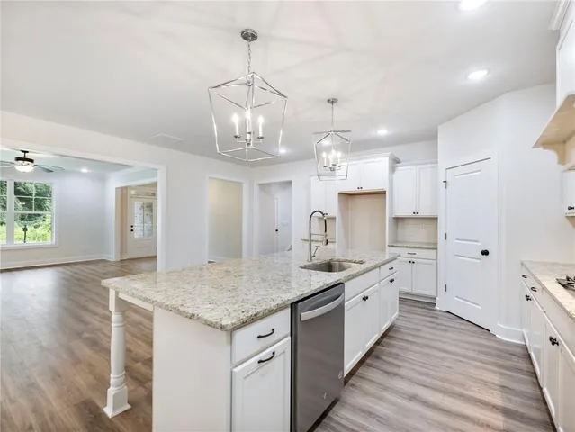 a large kitchen with kitchen island a sink stainless steel appliances and cabinets