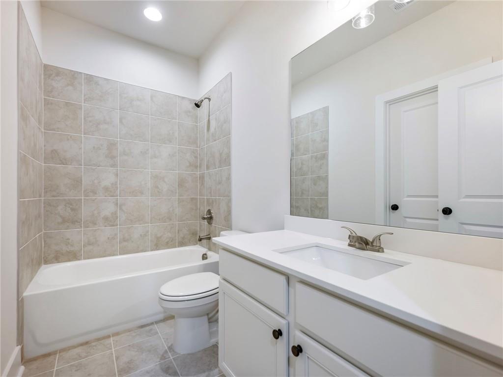490 Jackson Street Buford, GA 30518 - Photo 14 of 46 a bathroom with a granite countertop sink a toilet and bathtub