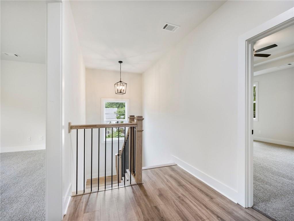 490 Jackson Street Buford, GA 30518 - Photo 22 of 46 a view of a hallway with wooden floor and a bathroom