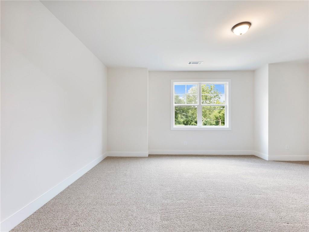 490 Jackson Street Buford, GA 30518 - Photo 23 of 46 an empty room with windows