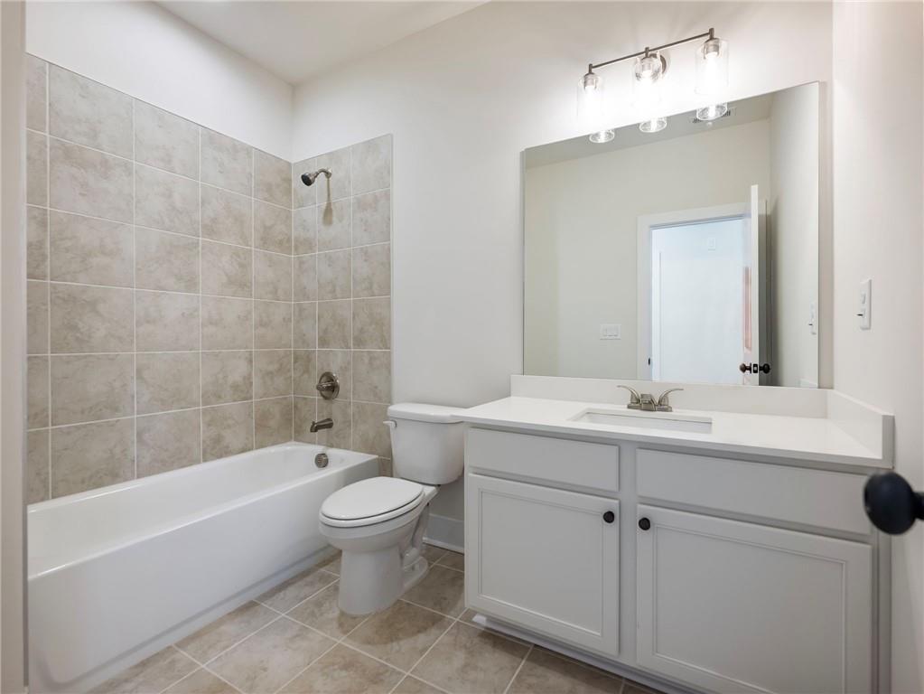 490 Jackson Street Buford, GA 30518 - Photo 34 of 46 a bathroom with a sink a toilet and a mirror