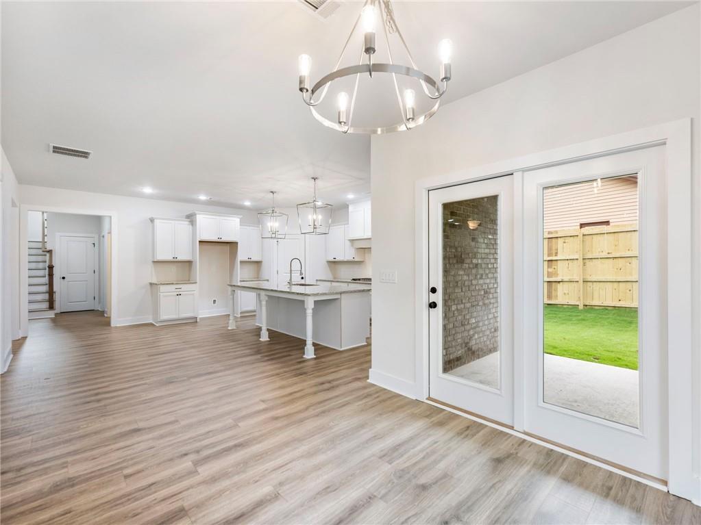 490 Jackson Street Buford, GA 30518 - Photo 8 of 46 a view of a kitchen with furniture and a floor to ceiling window