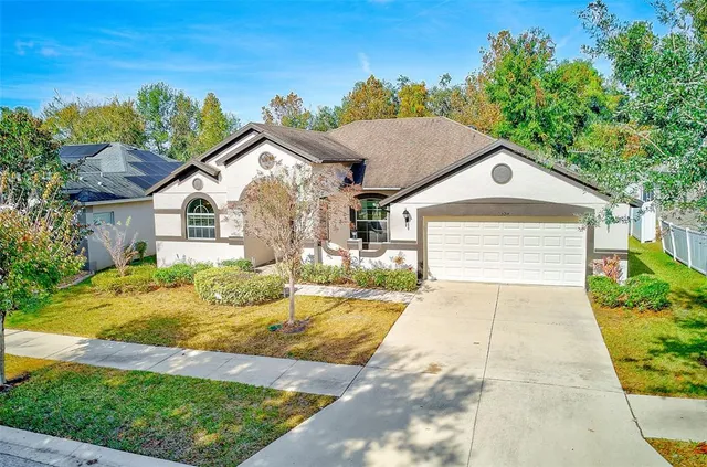 an aerial view of residential houses with outdoor space and trees
