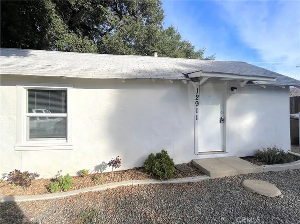 a small white house with a outdoor space