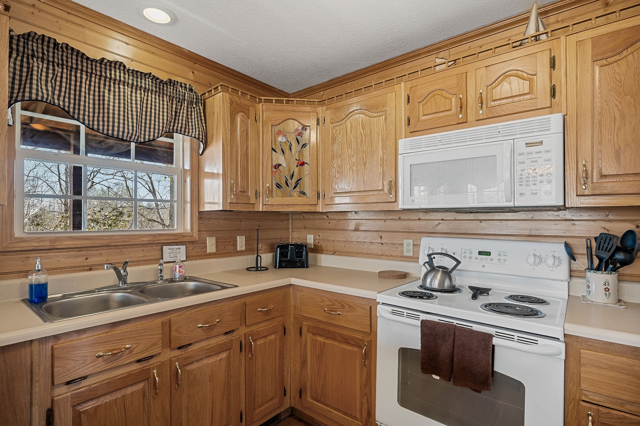 5606 Eastport Road Alpine, TN 38543 - Photo 23 of 44 a kitchen with stainless steel appliances granite countertop a sink a stove and cabinets