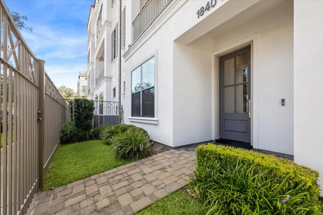 a view of a hallway with wooden floor and windows