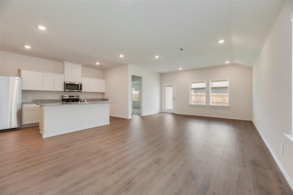 3407 Rendezvous Way Sherman, TX 75090 - Photo 4 of 17 Open-concept living space with wood-finish flooring, recessed lighting, and vaulted ceilings