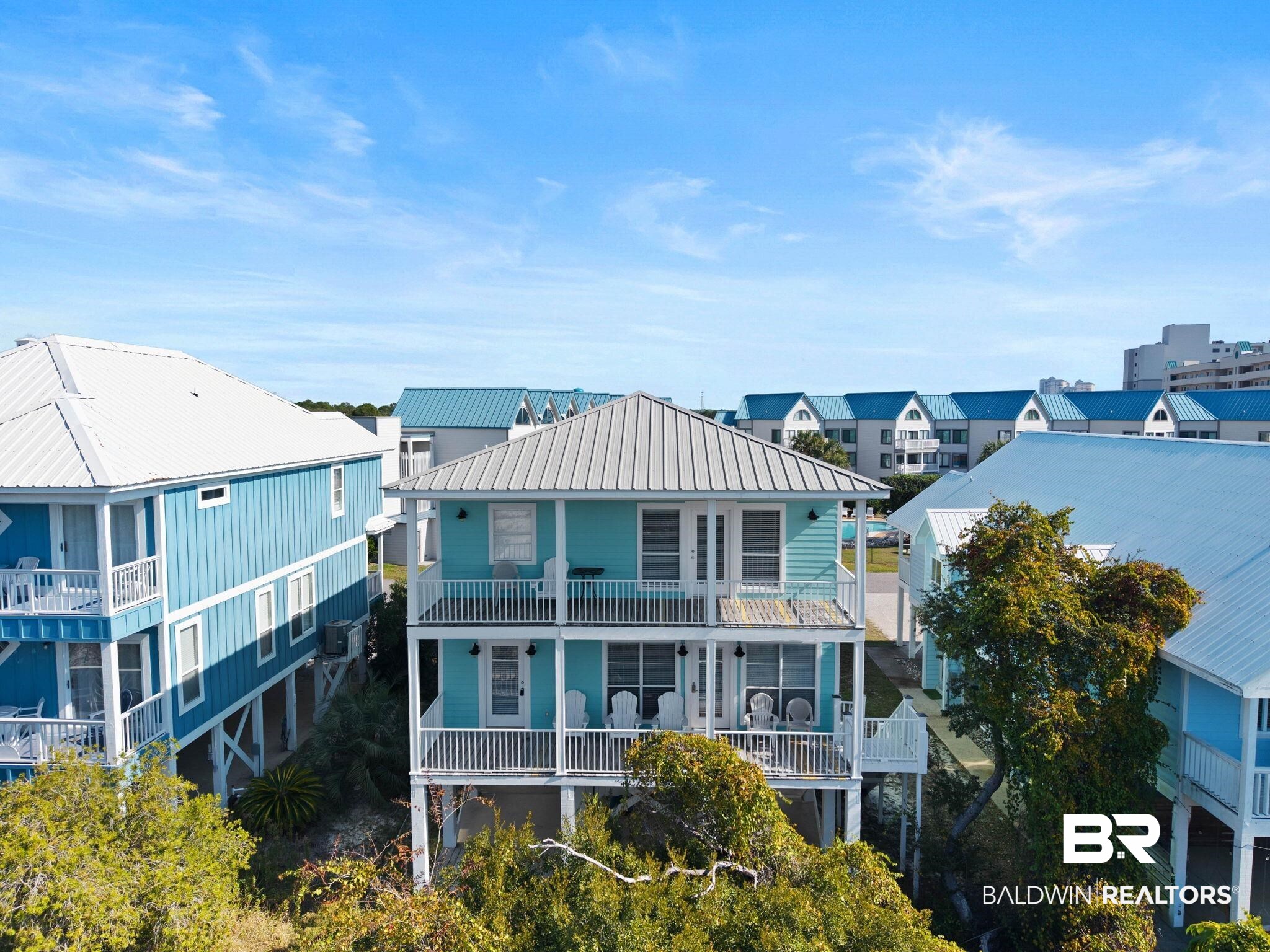545 Plantation Road, Unit 3 Gulf Shores, AL 36542 - Photo 49 of 54 Back of property featuring a metal roof and a residential view