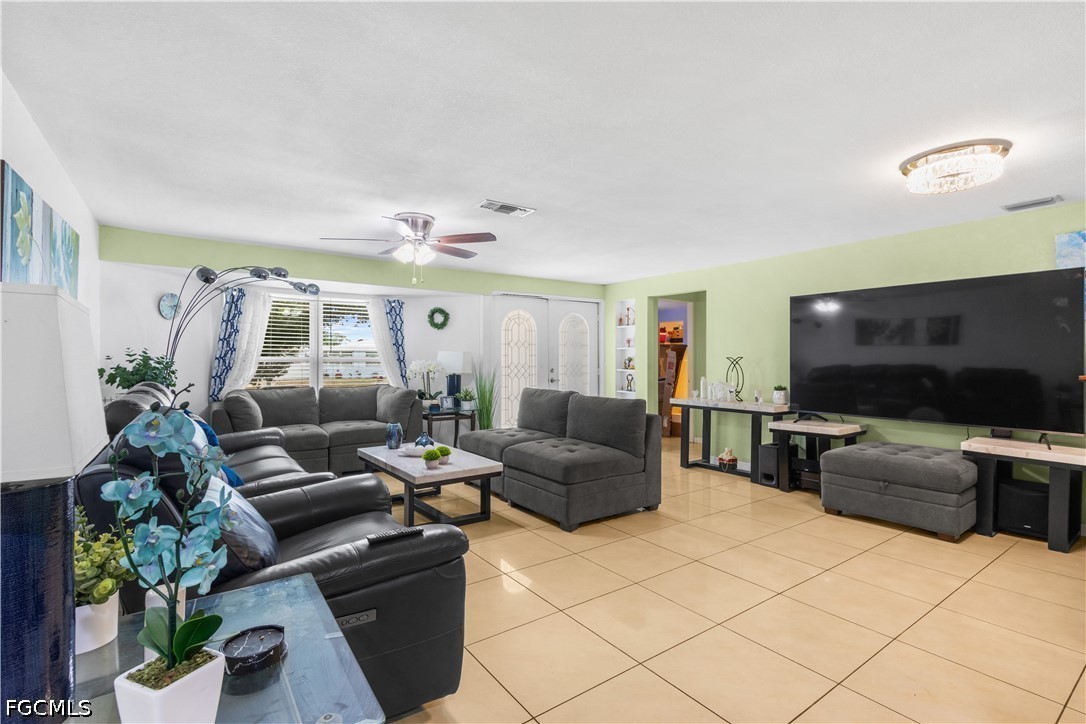 18 Illinois Road Lehigh Acres, FL 33936 - Photo 8 of 45 a living room with furniture and a flat screen tv