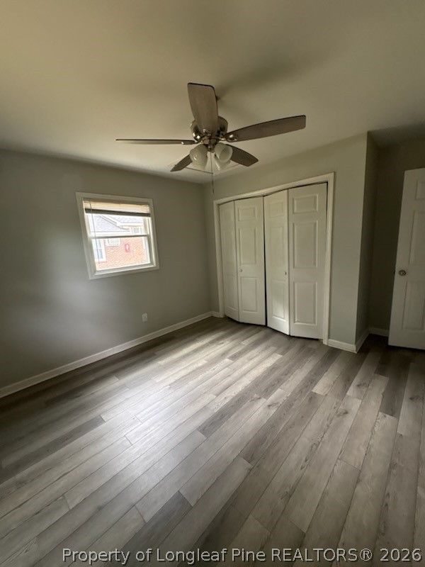 1051 Rulnick Street, Unit D Fayetteville, NC 28304 - Photo 5 of 5 an empty room with wooden floor ceiling fan and windows