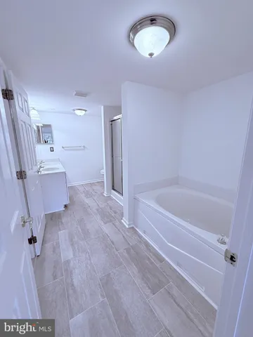 a spacious bathroom with a tub sink and toilet
