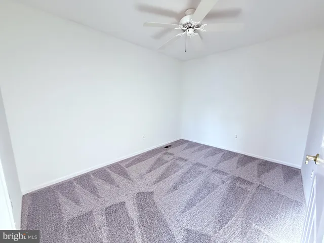 a view of a big room with a fan