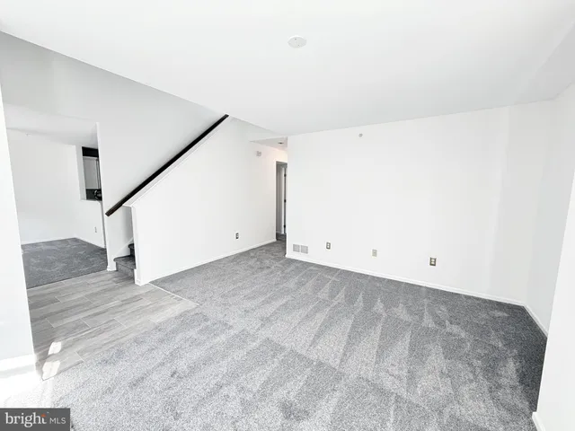 a view of a big room with closet and stairs