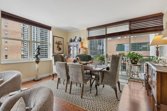 a dining room with furniture window and wooden floor