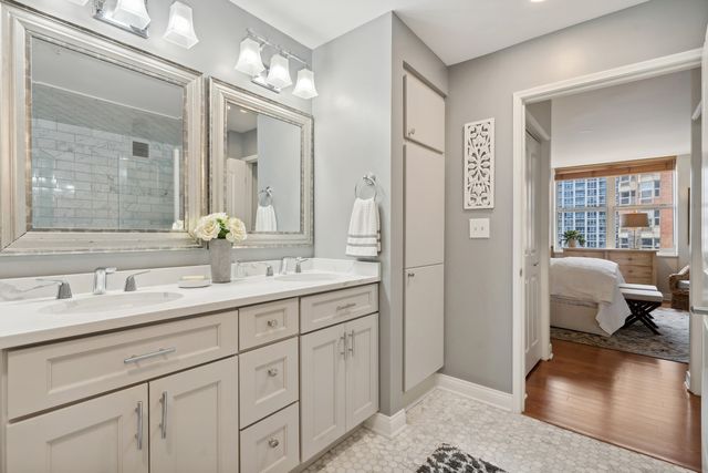a en suite bathroom with double sink and a mirror