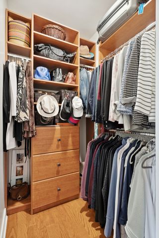 a view of walk in closet with clothes and shoes
