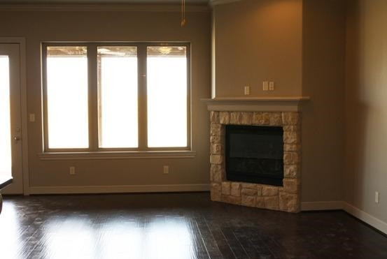 10306 Iola Lubbock, TX 79424 - Photo 3 of 10 a living room with a fireplace and a window