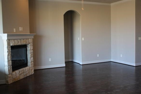 10306 Iola Lubbock, TX 79424 - Photo 5 of 10 a view of an empty room with wooden floor and a fireplace