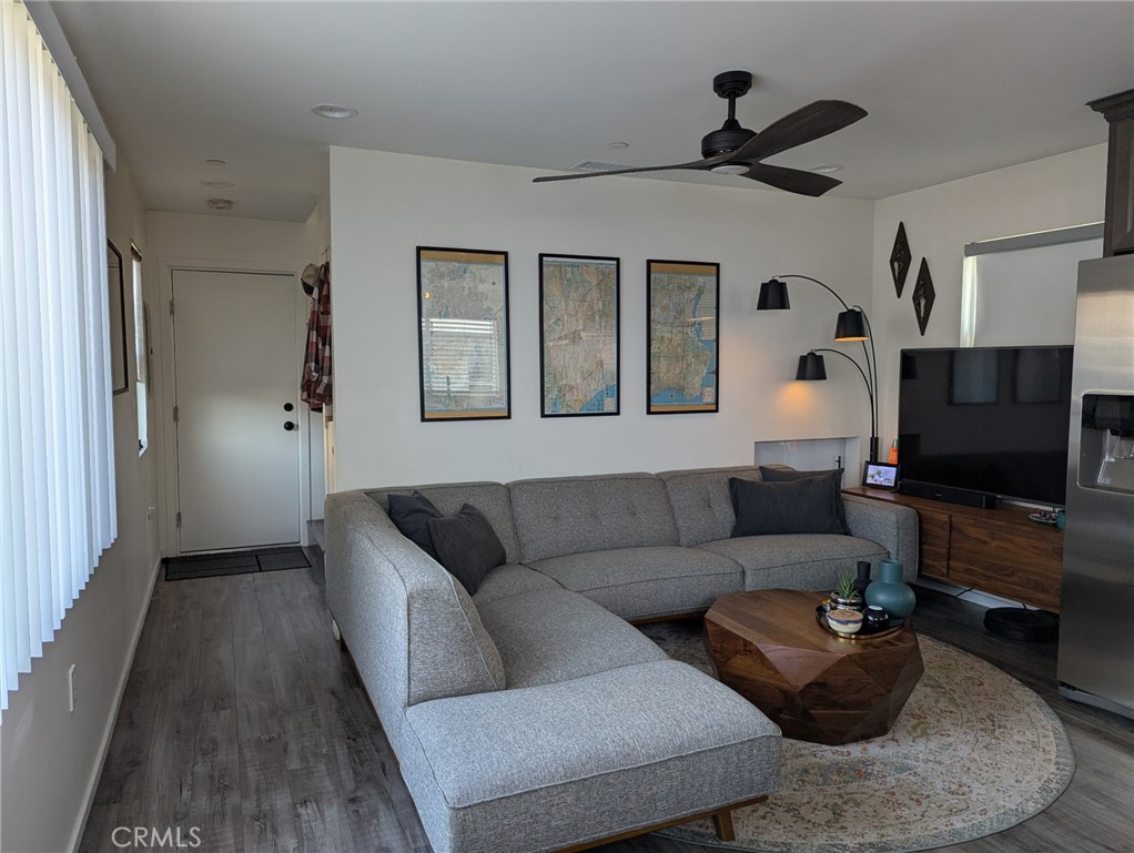 2526 Delaware Street Huntington Beach, CA 92648 - Photo 1 of 6 a living room with furniture and a flat screen tv