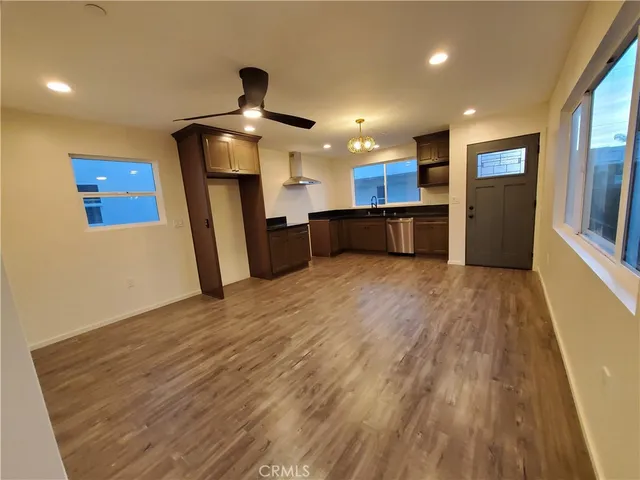 a view of a kitchen with a sink and a refrigerator